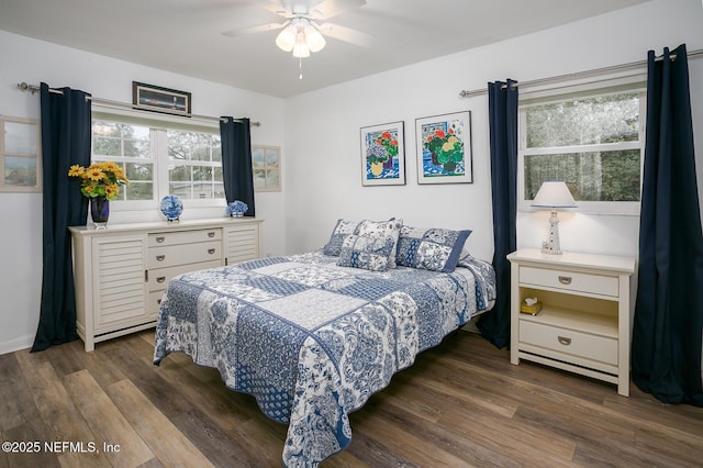 bedroom featuring multiple windows, wood finished floors, and ceiling fan