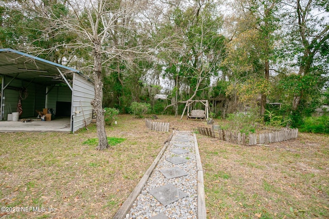 view of yard featuring an outbuilding, an outdoor structure, and a vegetable garden