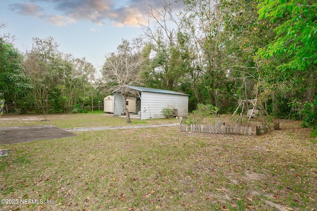 view of yard with an outbuilding and a storage shed