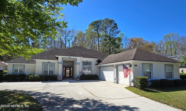 ranch-style house with stucco siding, driveway, and a garage