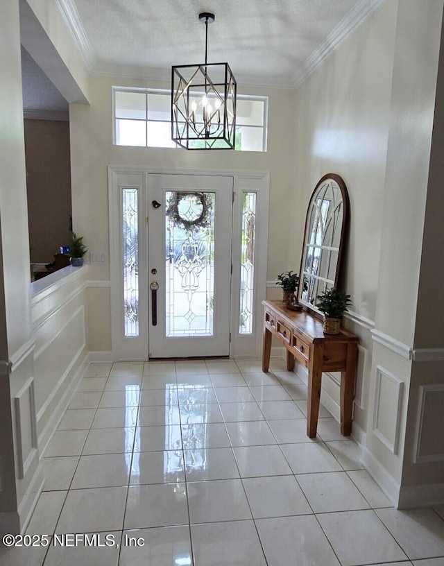 entryway featuring a decorative wall, plenty of natural light, and ornamental molding