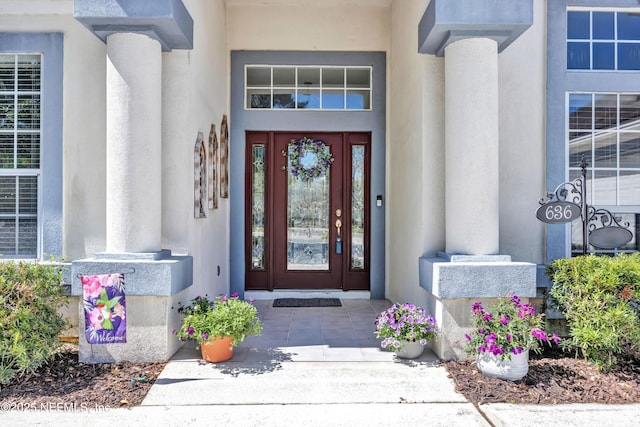 doorway to property with stucco siding