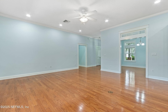 unfurnished room featuring visible vents, a ceiling fan, light wood-style floors, crown molding, and baseboards