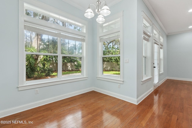 interior space with baseboards, ornamental molding, and hardwood / wood-style flooring