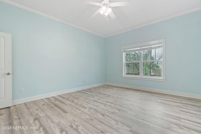 spare room featuring light wood finished floors, a ceiling fan, crown molding, and baseboards