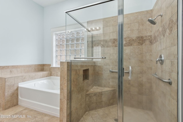 bathroom featuring tile patterned floors, a garden tub, and a stall shower