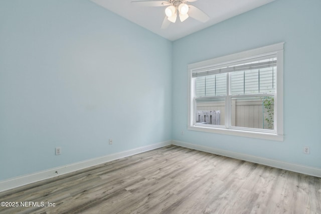 unfurnished room with wood finished floors, baseboards, and ceiling fan