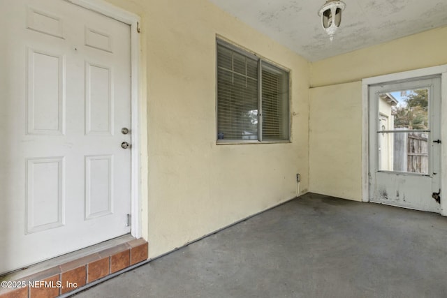 view of exterior entry featuring stucco siding