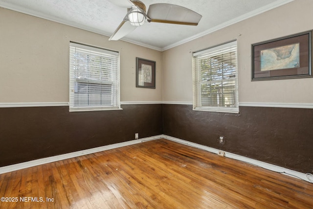 unfurnished room featuring a wealth of natural light, baseboards, ceiling fan, and hardwood / wood-style flooring