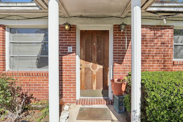 entrance to property with brick siding