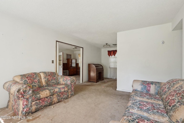 living area with a textured ceiling and carpet floors