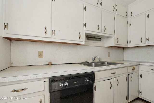 kitchen featuring light countertops, black dishwasher, and a sink