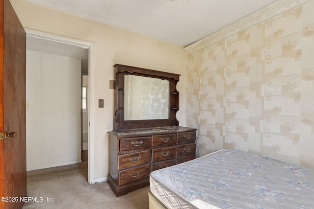 carpeted bedroom with wallpapered walls and baseboards