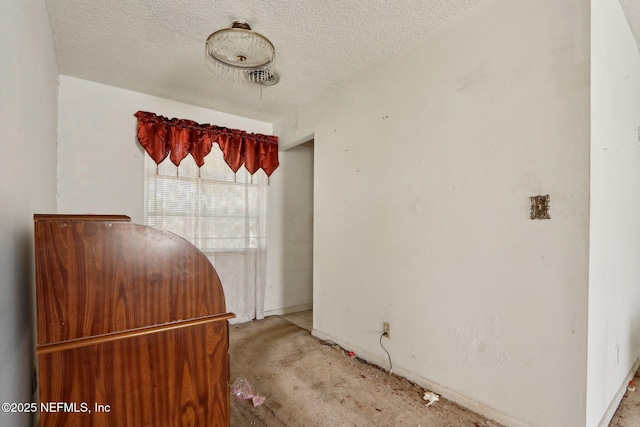 interior space featuring light colored carpet, visible vents, and a textured ceiling