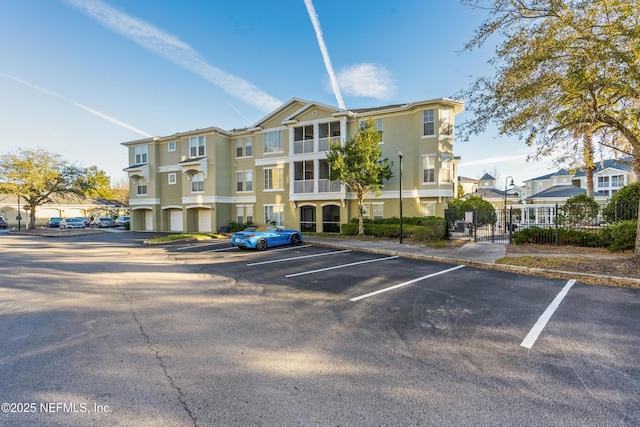 view of building exterior featuring a residential view and uncovered parking