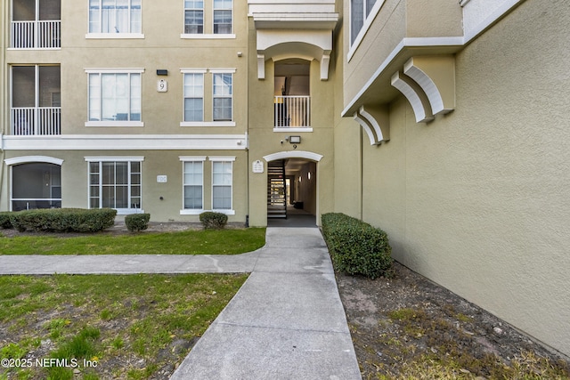 doorway to property with stucco siding