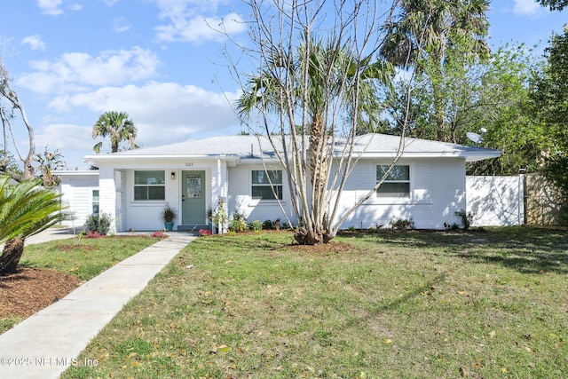 single story home with a front yard and fence