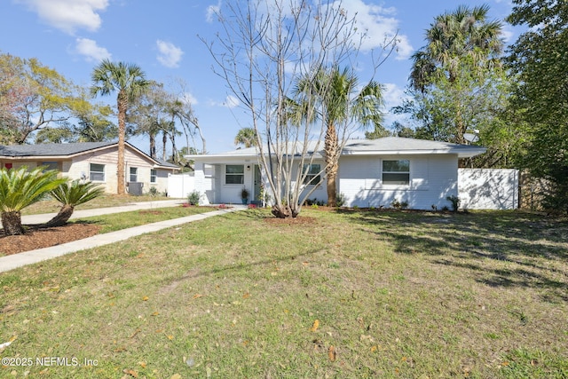 ranch-style home with a front lawn and fence