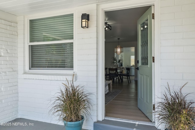 property entrance with brick siding