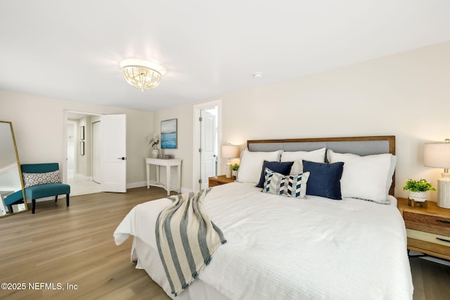 bedroom featuring baseboards and wood finished floors