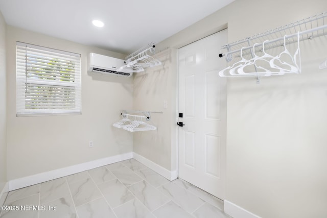 washroom with recessed lighting, marble finish floor, an AC wall unit, and baseboards