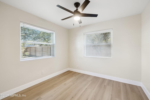 empty room with a ceiling fan, baseboards, and light wood-type flooring