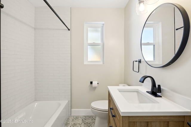 full bath featuring a wealth of natural light, toilet, vanity, and baseboards