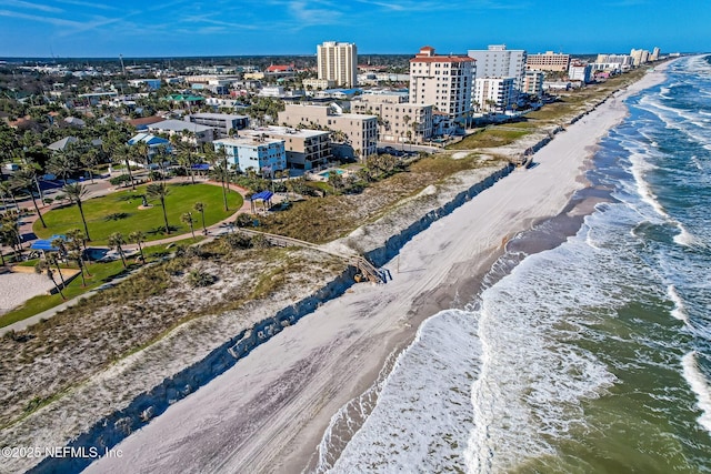 drone / aerial view with a city view, a view of the beach, and a water view