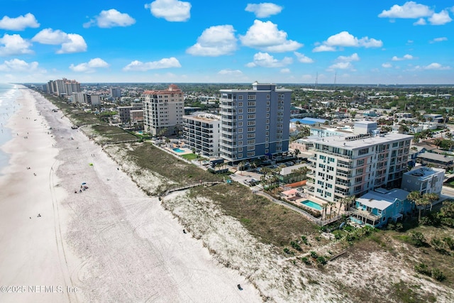 birds eye view of property featuring a view of city, a water view, and a view of the beach