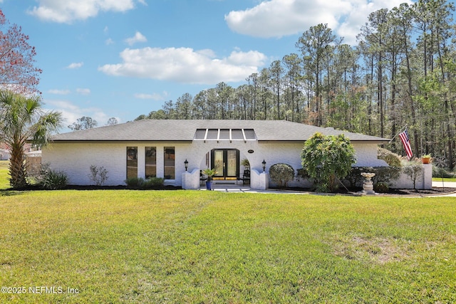 view of front of house with french doors and a front lawn