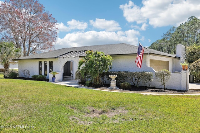 view of front of house with a front yard and an attached garage