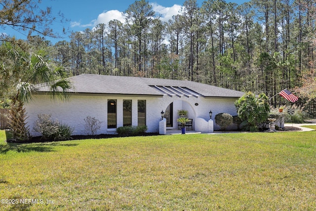 view of front of property with a front yard and stucco siding