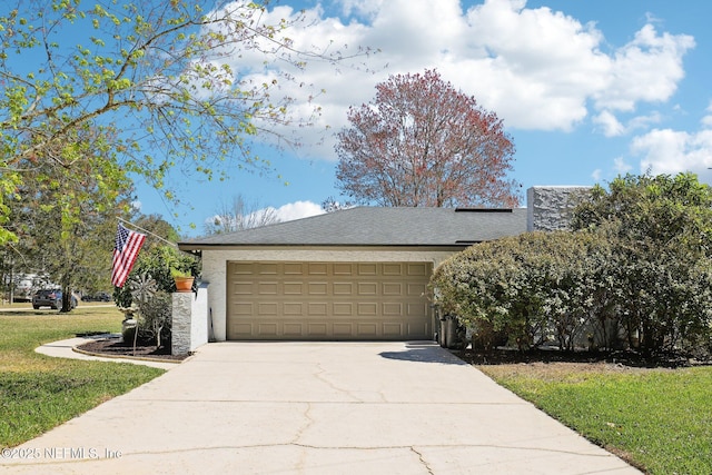 view of front of property featuring a shingled roof, a front lawn, concrete driveway, stucco siding, and a garage