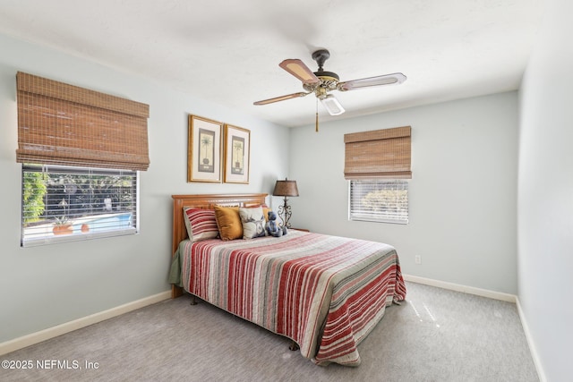 carpeted bedroom with a ceiling fan and baseboards