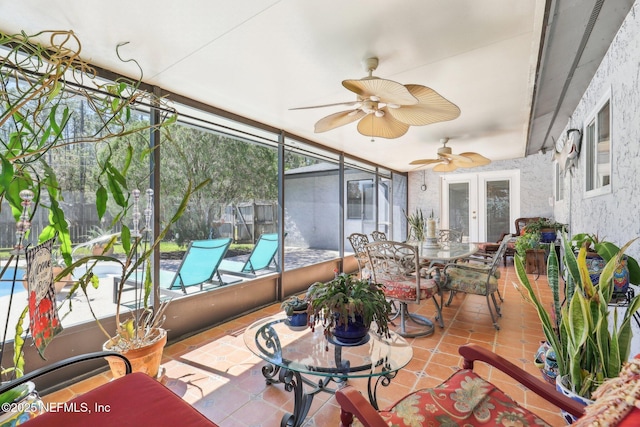 sunroom featuring ceiling fan