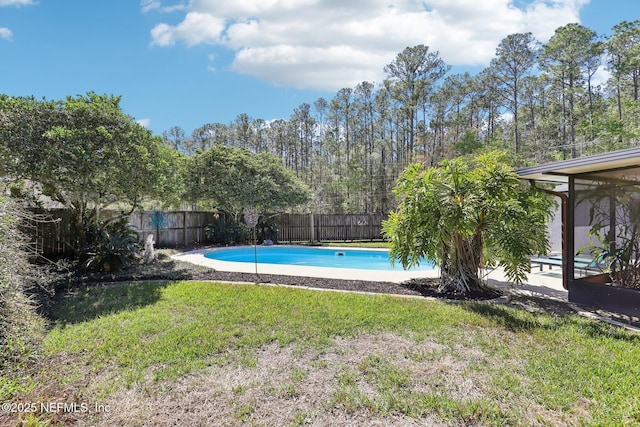 view of swimming pool with a yard, a fenced in pool, and a fenced backyard