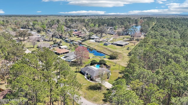 bird's eye view featuring a view of trees and a water view