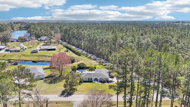 aerial view with a forest view and a water view