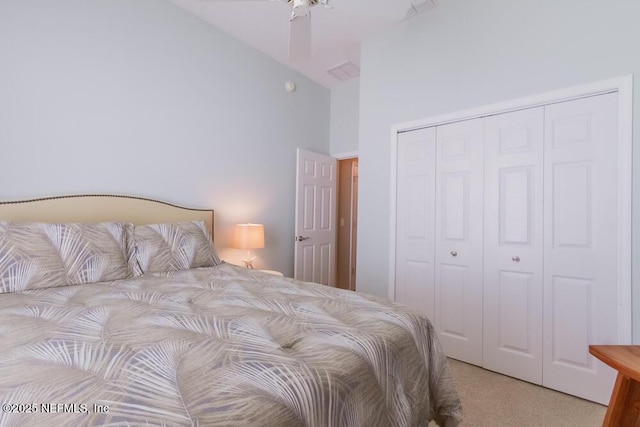 bedroom with carpet flooring, a closet, and high vaulted ceiling