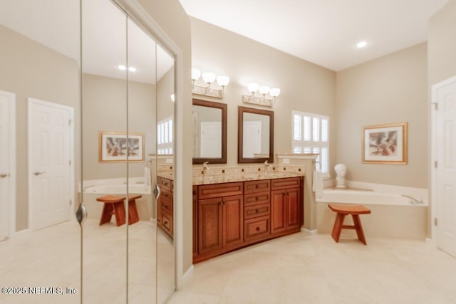 full bath featuring double vanity, recessed lighting, a sink, tile patterned flooring, and a washtub