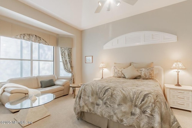 carpeted bedroom featuring multiple windows and a ceiling fan