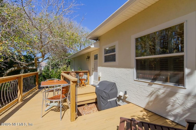 wooden deck with a grill