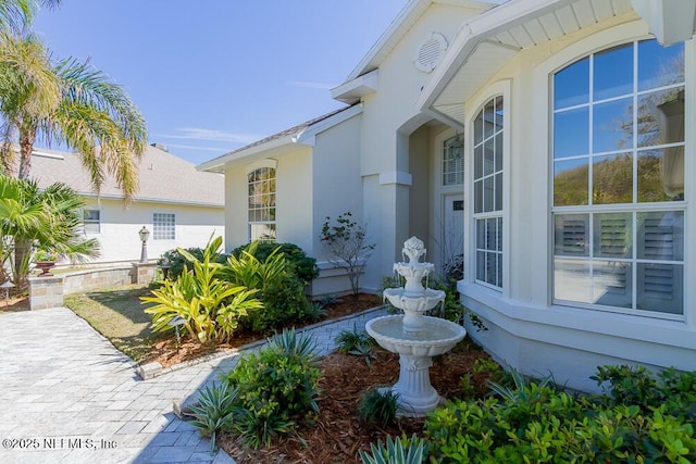 doorway to property with stucco siding