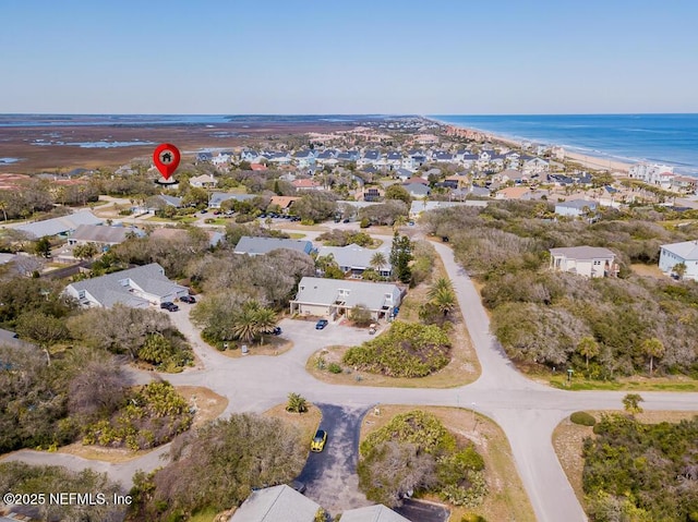 birds eye view of property featuring a residential view, a water view, and a beach view