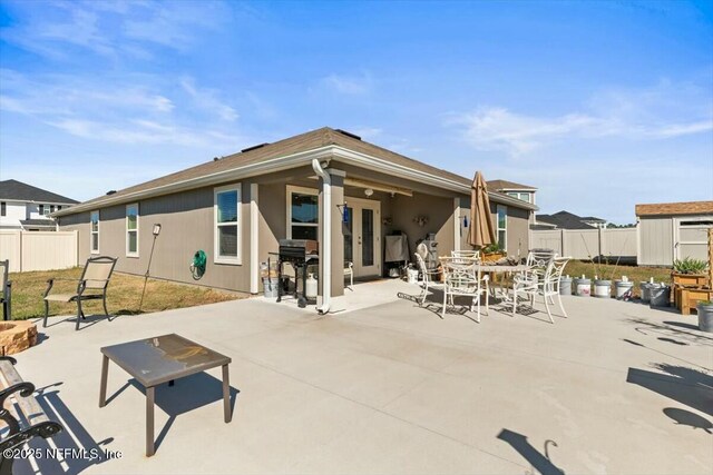 back of property featuring a patio, french doors, and a fenced backyard