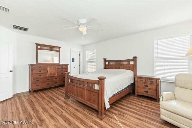 bedroom with visible vents, light wood-style flooring, and a ceiling fan