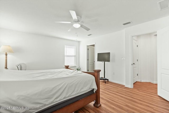 bedroom with visible vents, baseboards, a ceiling fan, and wood finished floors