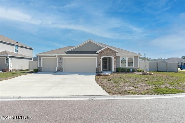 view of front of house featuring a garage, stone siding, concrete driveway, and fence