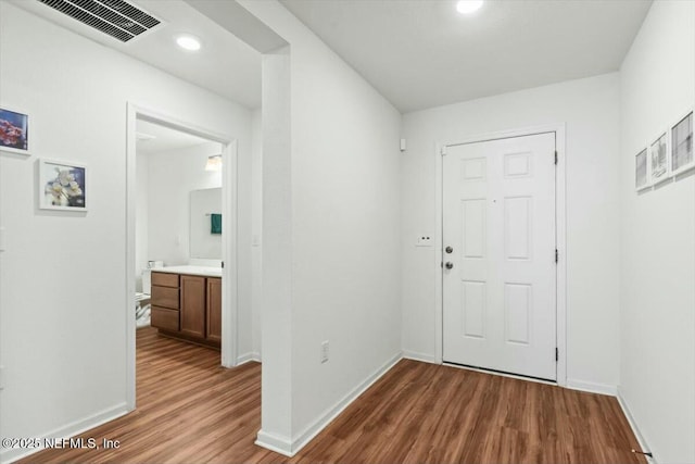 interior space featuring recessed lighting, visible vents, baseboards, and wood finished floors