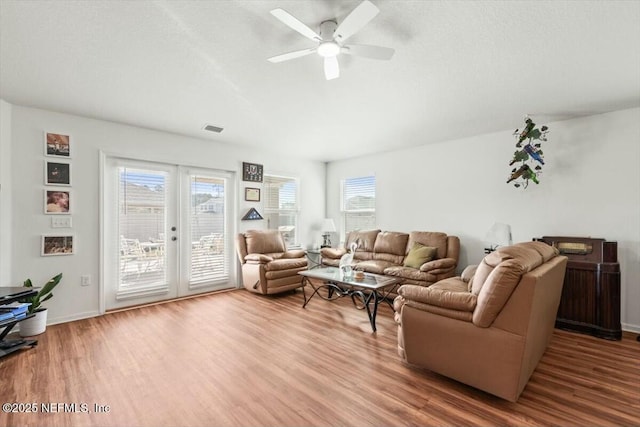 living area featuring visible vents, french doors, and wood finished floors